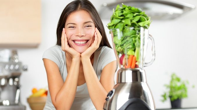 Green smoothie woman making vegetable smoothies